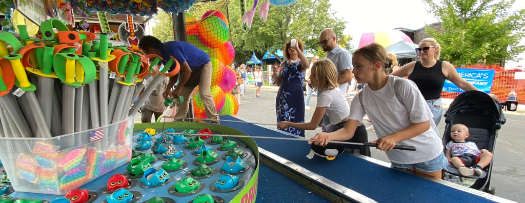 Kids playing a fishing carnival game at Schaumburg's Septemberfest.